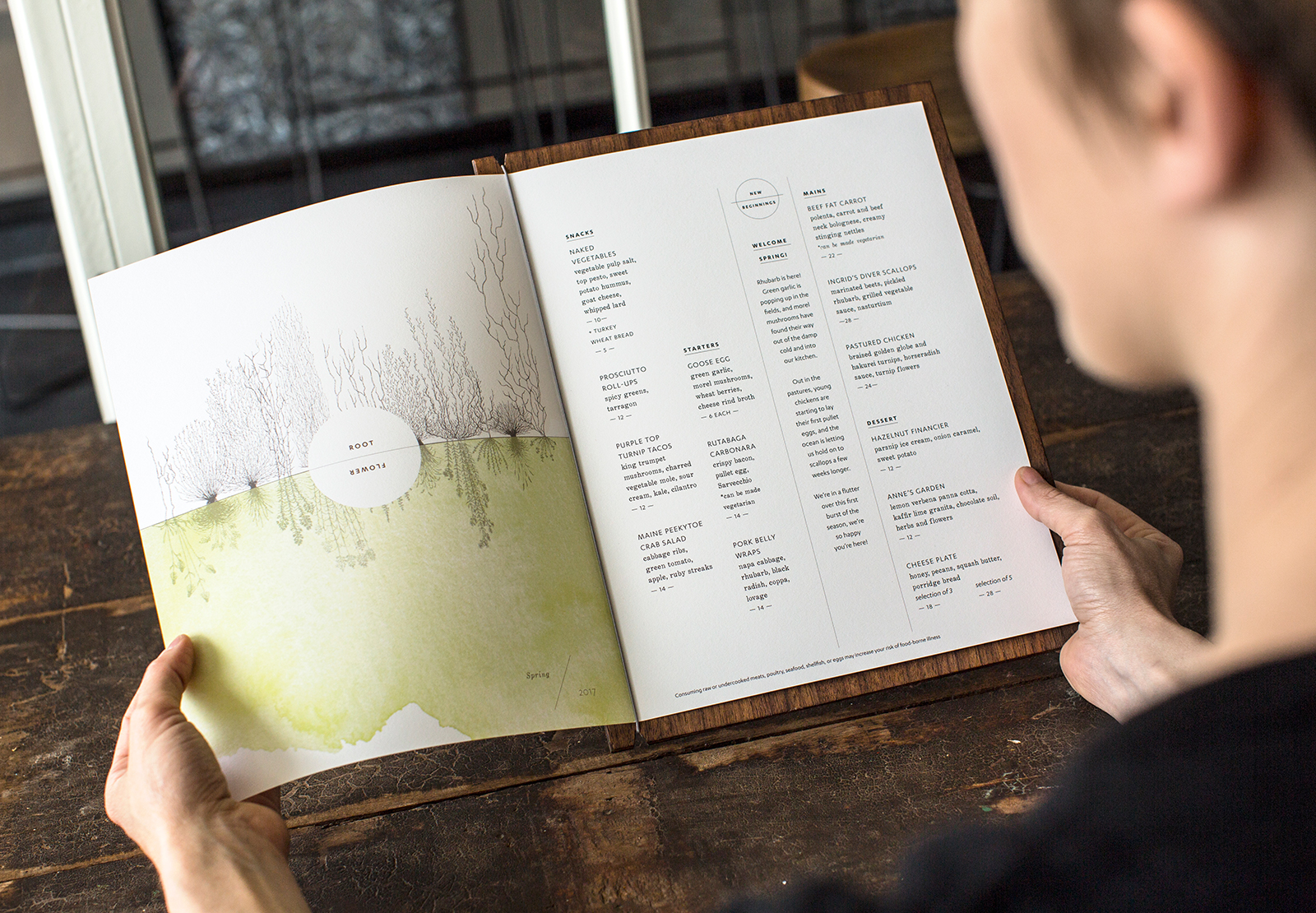 Woman holding Vicia menu